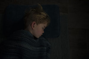 jonah sleeping on the floor under a blanket - before editing services