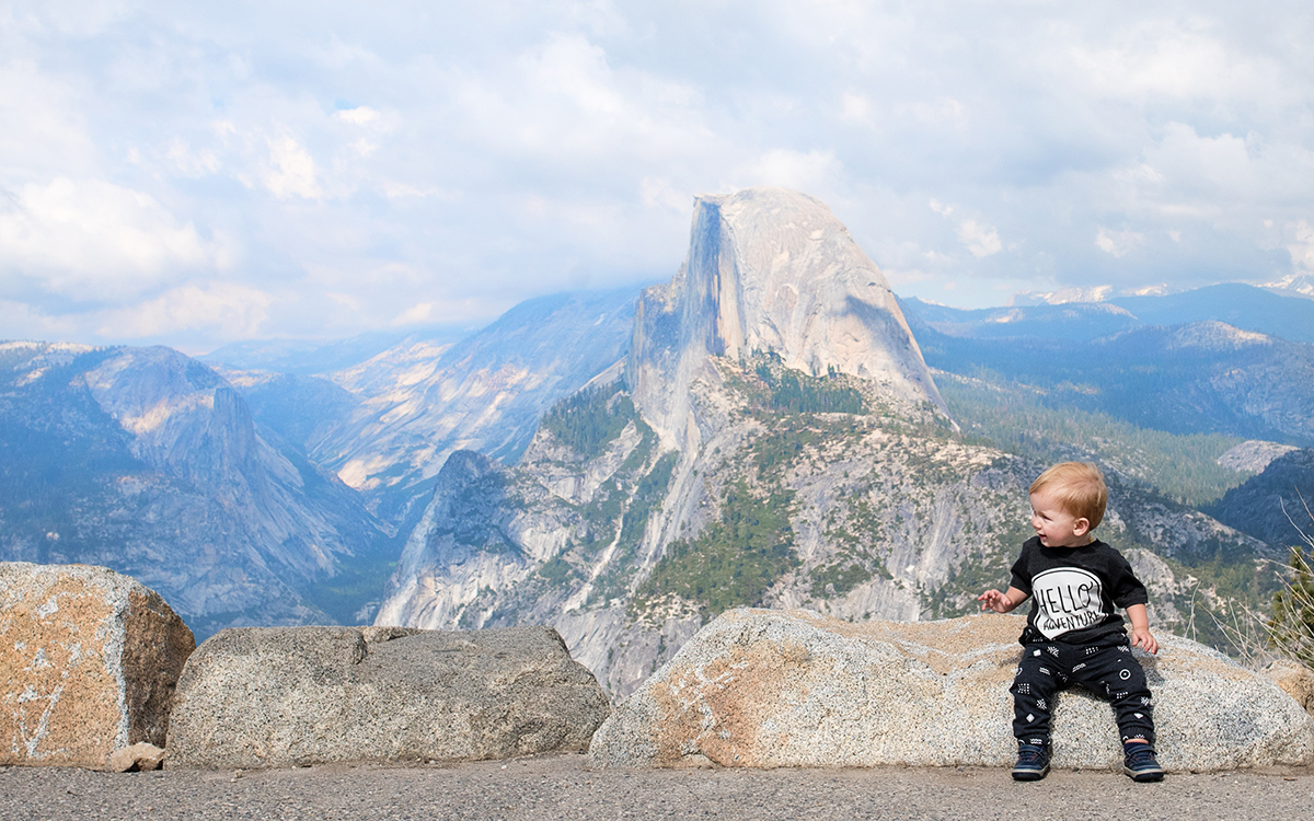 zachary sitting on a rock with half-dome in the background. Found on the Contact page for Life in Motion Photography.